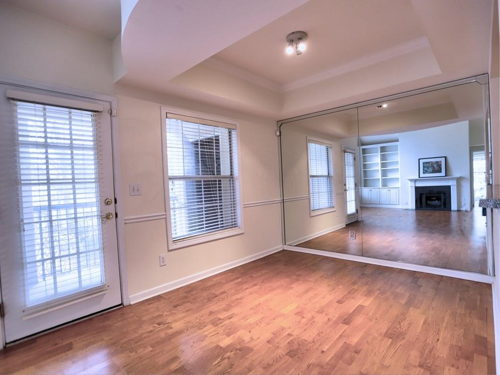 3636 Habersham Road Northwest, Unit 2308 Atlanta, GA 30305 - Photo 11 of 42 an empty room with wooden floor and windows