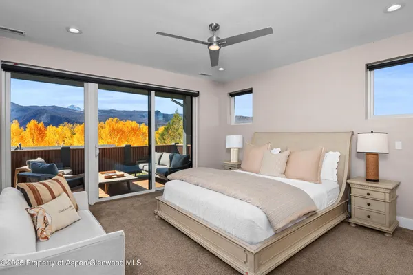 a bedroom with a bed and glass door