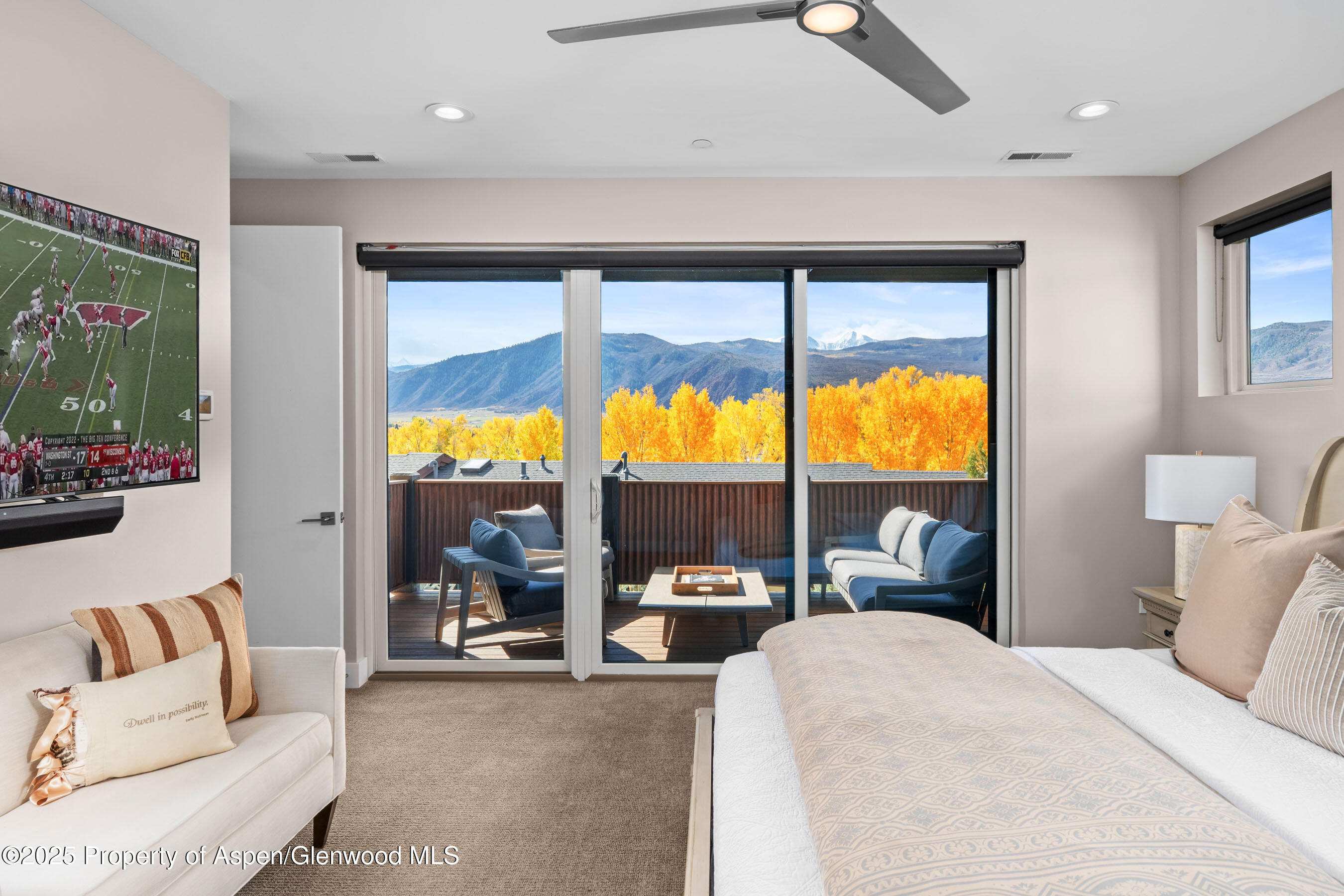 250 Overlook Ridge, Unit 250 Carbondale, CO 81623 - Photo 12 of 41 a living room with large windows and a flat screen tv