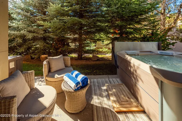 a view of a patio with chairs and a table