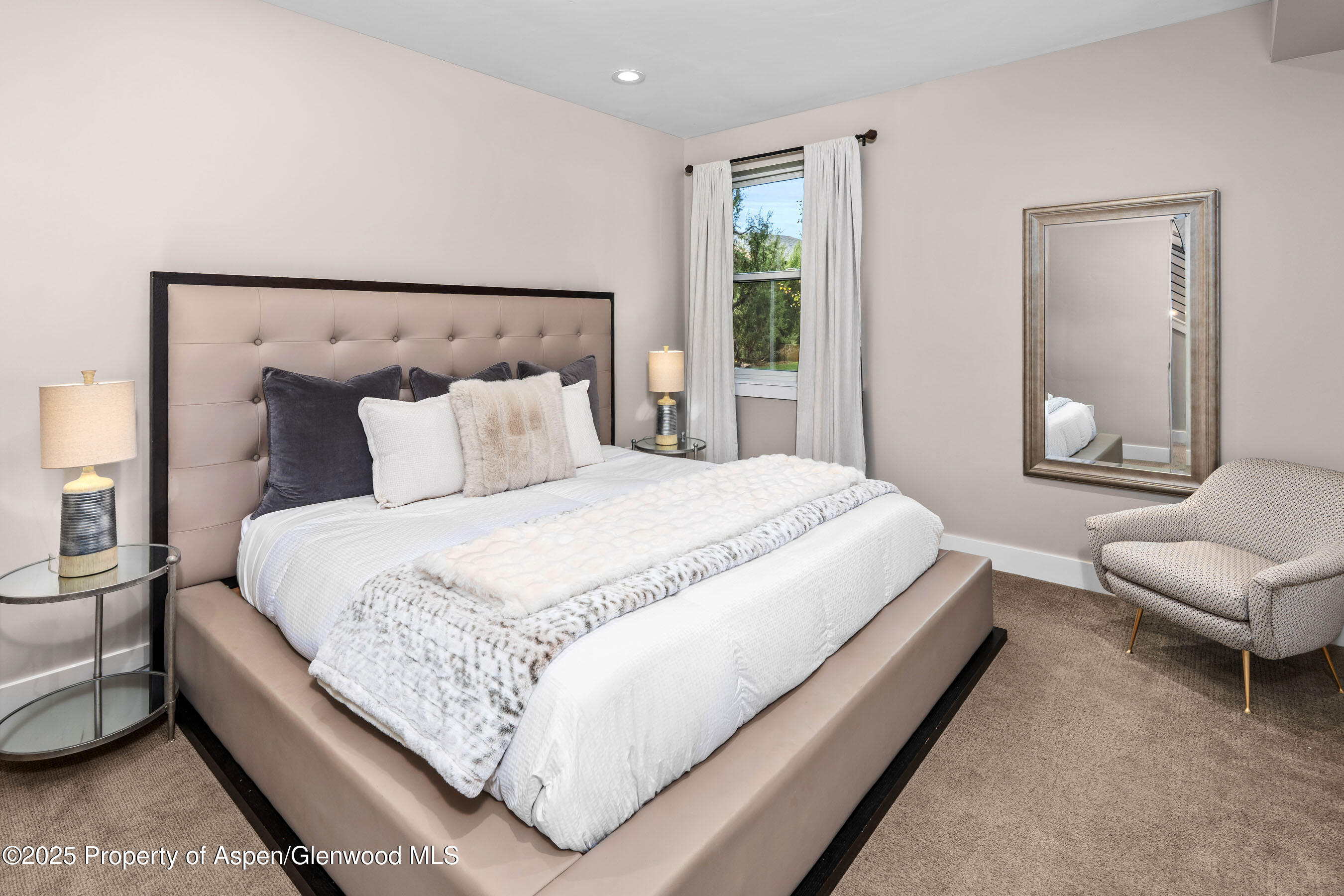 250 Overlook Ridge, Unit 250 Carbondale, CO 81623 - Photo 24 of 41 a large bed sitting in a bedroom next to a window