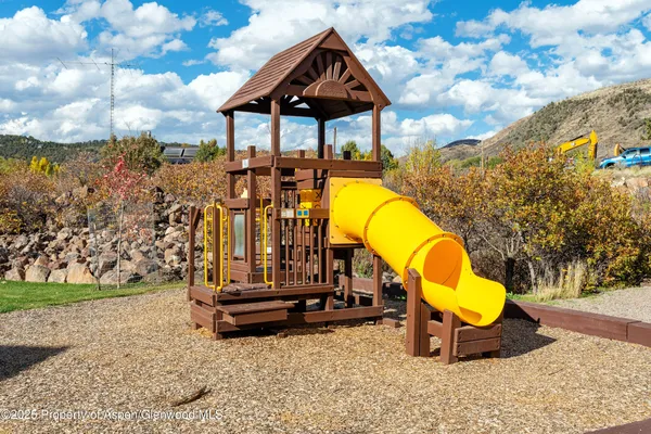 a view of a swimming pool with a bench and yard