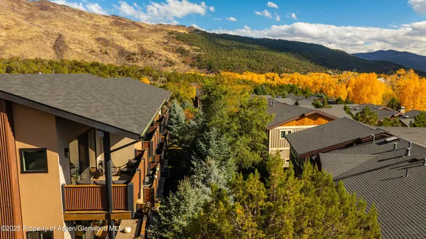 a view of a balcony with chair and wooden floor