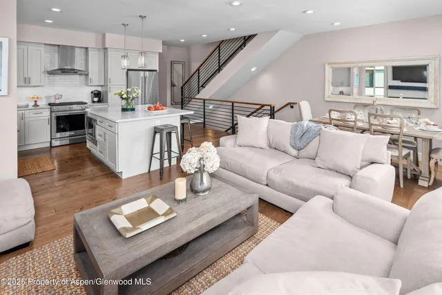 a living room with furniture kitchen and a table