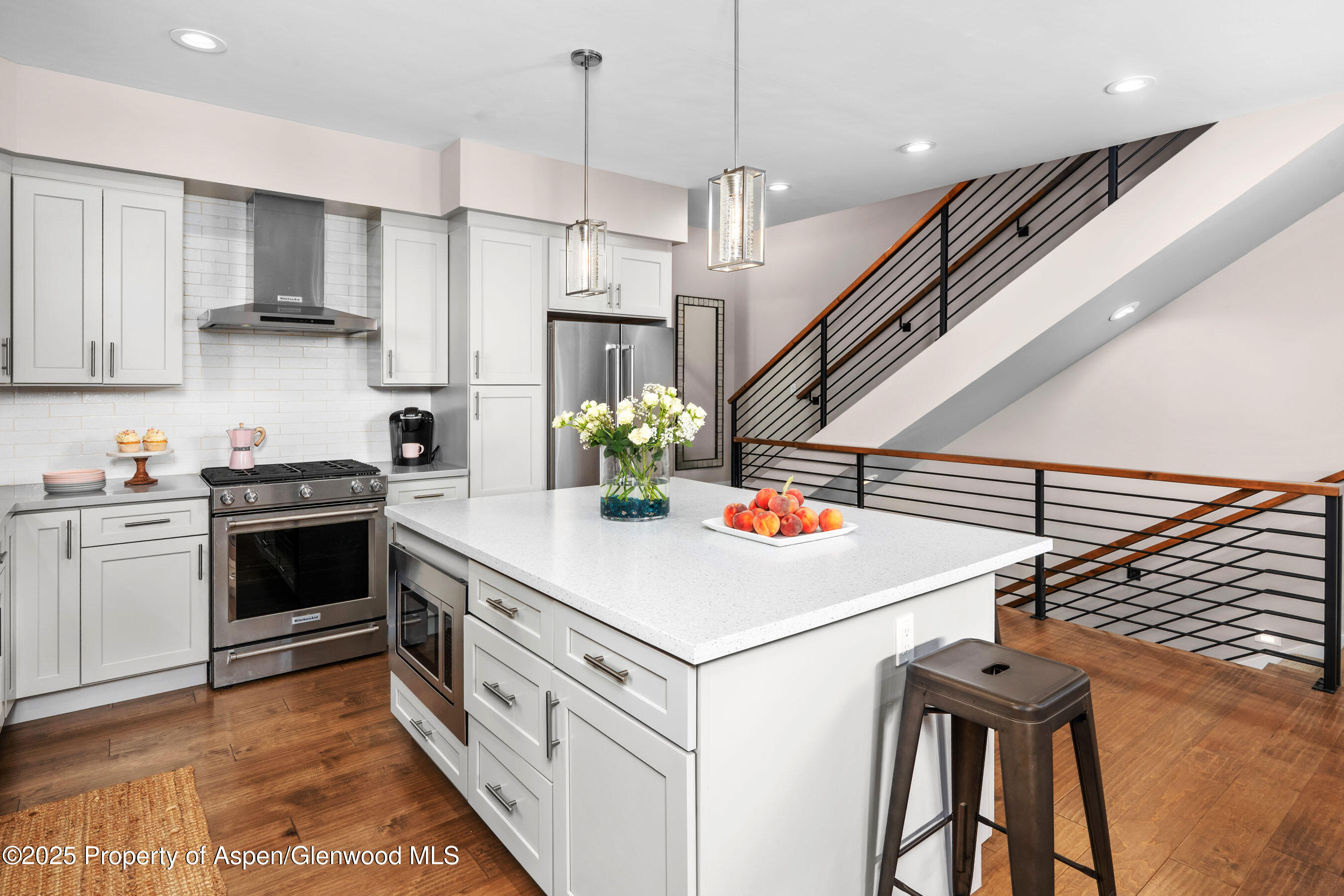 250 Overlook Ridge, Unit 250 Carbondale, CO 81623 - Photo 6 of 41 a kitchen with stainless steel appliances a stove top oven a sink dishwasher and a refrigerator with wooden floor