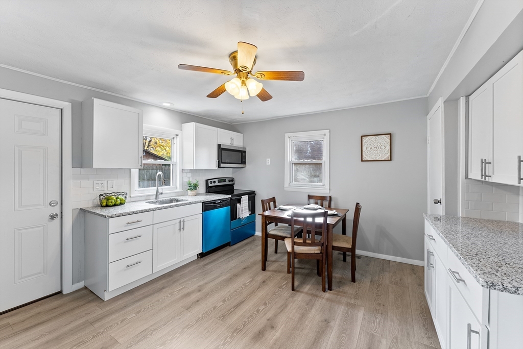 195 Almira Road Springfield, MA 01119 - Photo 11 of 41 a kitchen with a table chairs and wooden floor