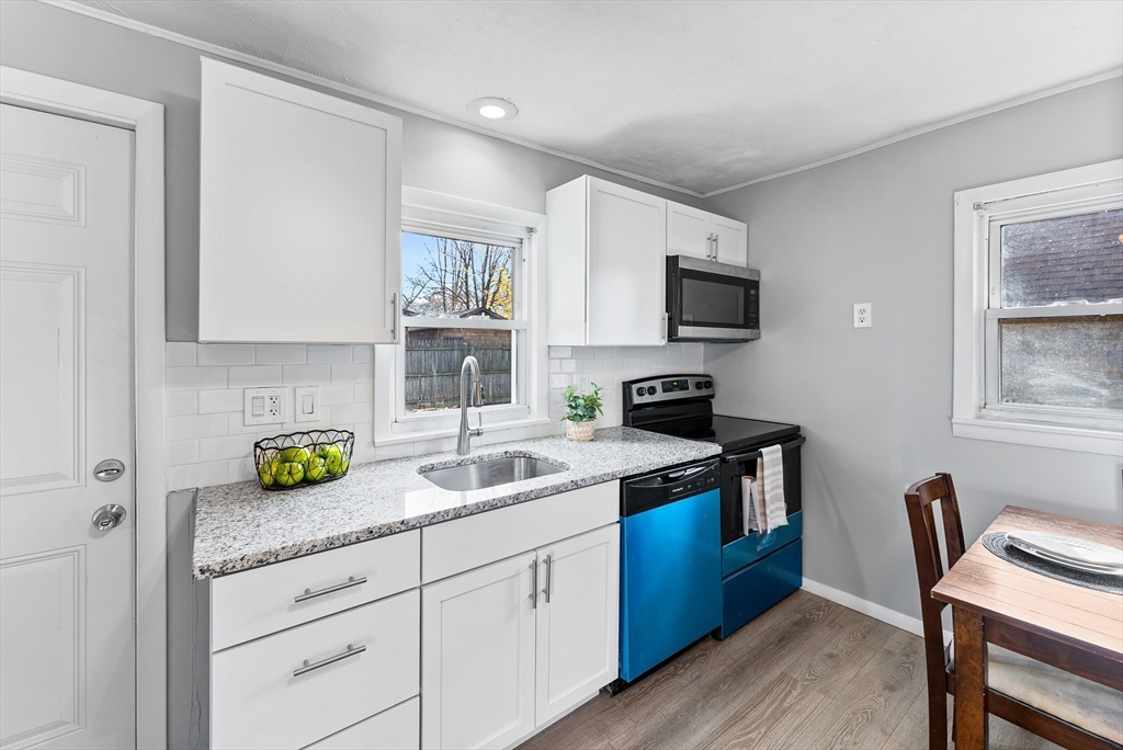 195 Almira Road Springfield, MA 01119 - Photo 12 of 41 a kitchen with a sink a stove and cabinets