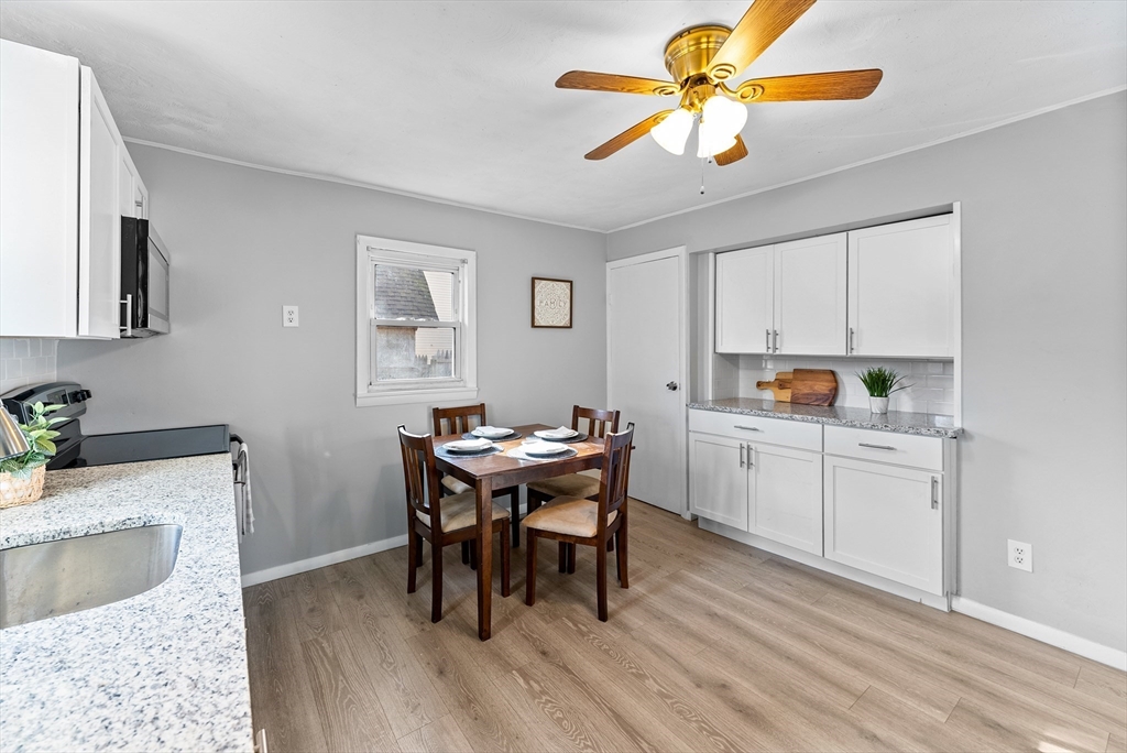 195 Almira Road Springfield, MA 01119 - Photo 13 of 41 a kitchen with a dining table chairs and white appliances
