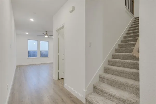 a view of an entryway with wooden floor