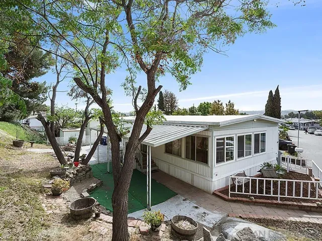 a view of a house with backyard porch and sitting area