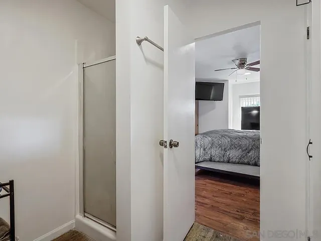 a en suite bathroom with a granite countertop sink and a mirror