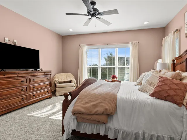 a bedroom with a bed and flat screen tv