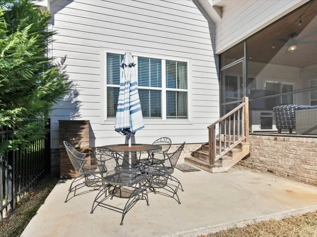 a view of a patio with table and chairs and potted plants