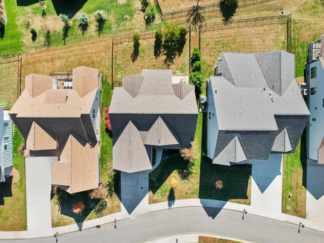 an aerial view of a house with yard and patio