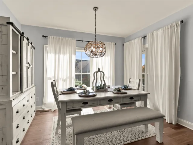 a dining room with furniture and window