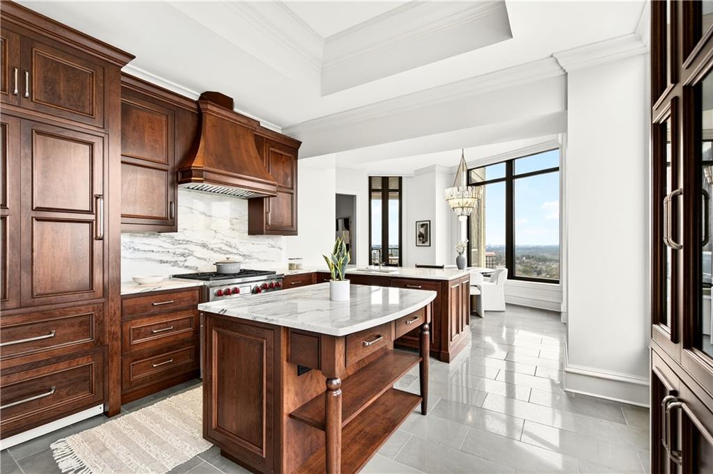 3376 Peachtree Road Northeast, Unit 41A Atlanta, GA 30326 - Photo 26 of 76 a kitchen with stainless steel appliances granite countertop a stove top oven a sink and a refrigerator