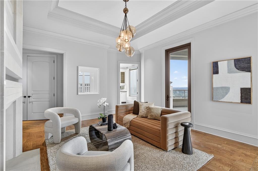 3376 Peachtree Road Northeast, Unit 41A Atlanta, GA 30326 - Photo 32 of 76 a living room with furniture a chandelier and a window