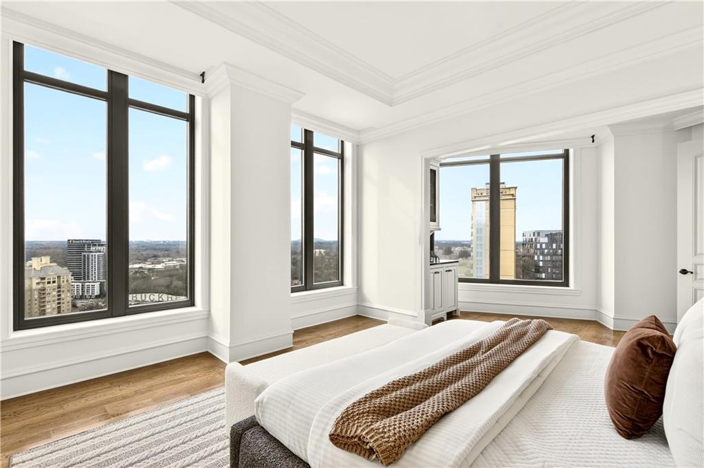 3376 Peachtree Road Northeast, Unit 41A Atlanta, GA 30326 - Photo 35 of 76 a bedroom with a large bed and a large window
