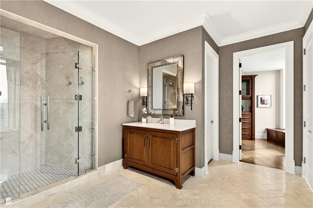 3376 Peachtree Road Northeast, Unit 41A Atlanta, GA 30326 - Photo 42 of 76 a bathroom with a sink a mirror and a shower