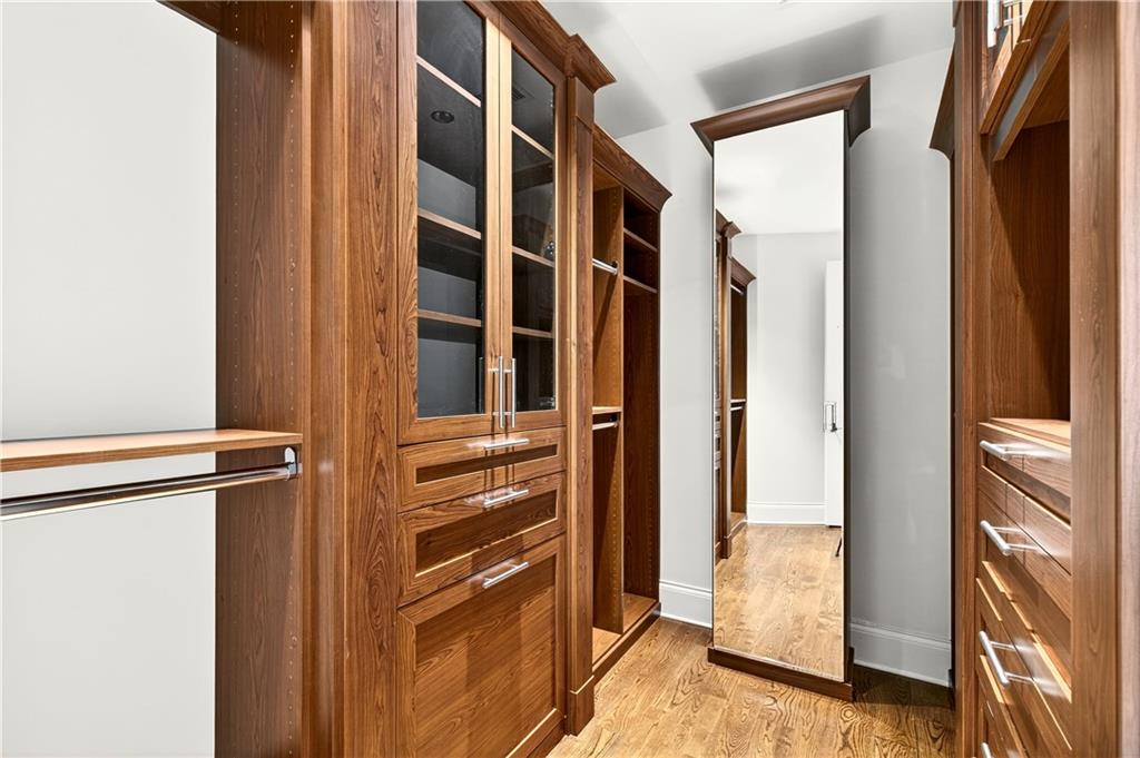 3376 Peachtree Road Northeast, Unit 41A Atlanta, GA 30326 - Photo 46 of 76 a view of walk in closet with clothes and shoes