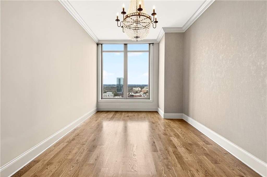 3376 Peachtree Road Northeast, Unit 41A Atlanta, GA 30326 - Photo 50 of 76 an empty room with wooden floor and windows