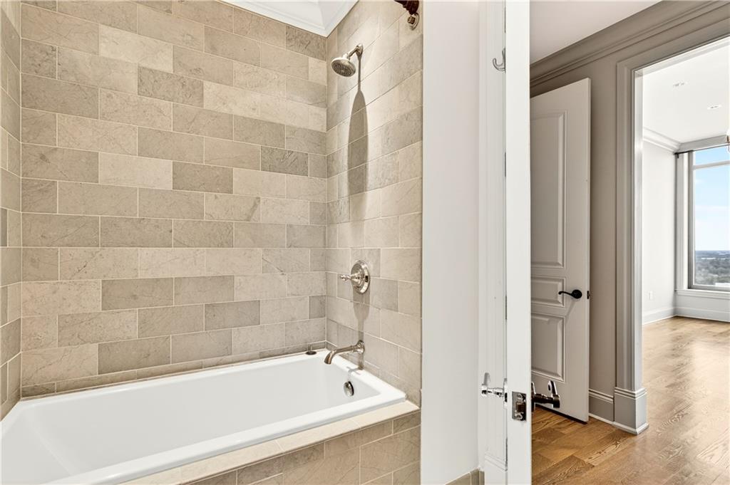 3376 Peachtree Road Northeast, Unit 41A Atlanta, GA 30326 - Photo 54 of 76 a bathroom with a bathtub and a shower