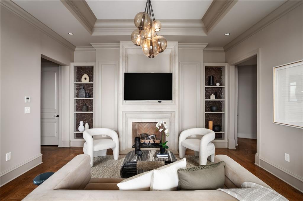 3376 Peachtree Road Northeast, Unit 41A Atlanta, GA 30326 - Photo 56 of 76 a living room with fireplace furniture and a flat screen tv