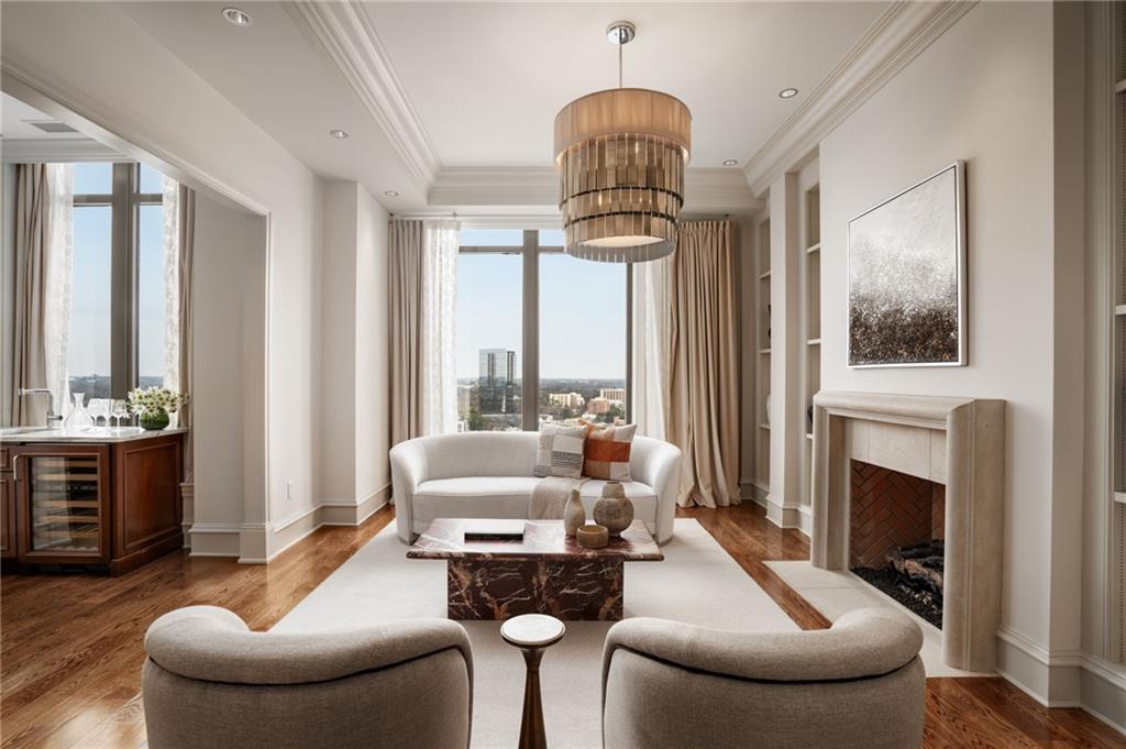 3376 Peachtree Road Northeast, Unit 41A Atlanta, GA 30326 - Photo 65 of 76 a living room with furniture a fireplace and a chandelier