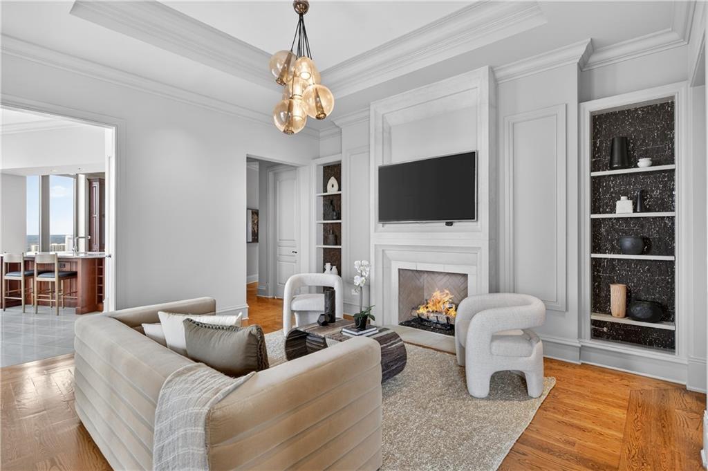 3376 Peachtree Road Northeast, Unit 41A Atlanta, GA 30326 - Photo 9 of 76 a living room with furniture a fireplace and a flat screen tv