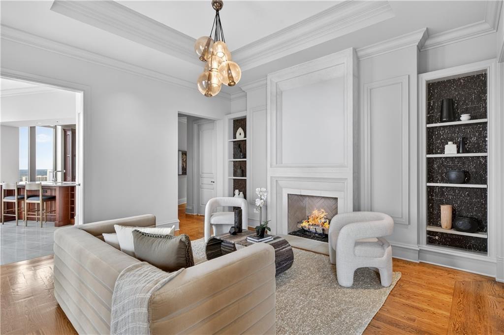 3376 Peachtree Road Northeast, Unit 41A Atlanta, GA 30326 - Photo 10 of 76 a living room with furniture a fireplace and a chandelier