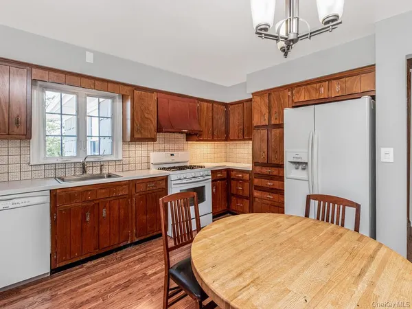a open kitchen with stainless steel appliances granite countertop a sink stove and refrigerator