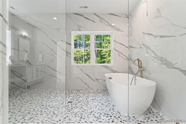 a living room with furniture a chandelier and a fireplace