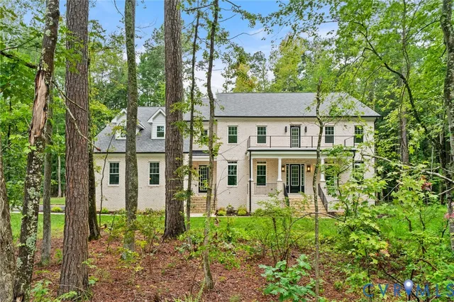 a spacious bedroom with a bed a couch and a window