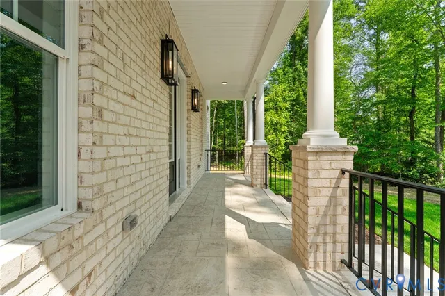 a view of a livingroom with wooden floor and a bathroom