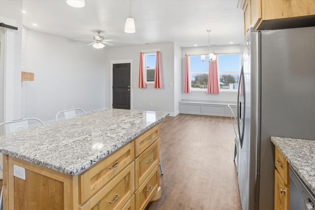 1009 High Creek Road Cove, UT 84320 - Photo 55 of 79 ADU Kitchen with stainless steel appliances, light stone counters, pendant lighting, a kitchen island, and dark wood-type flooring
