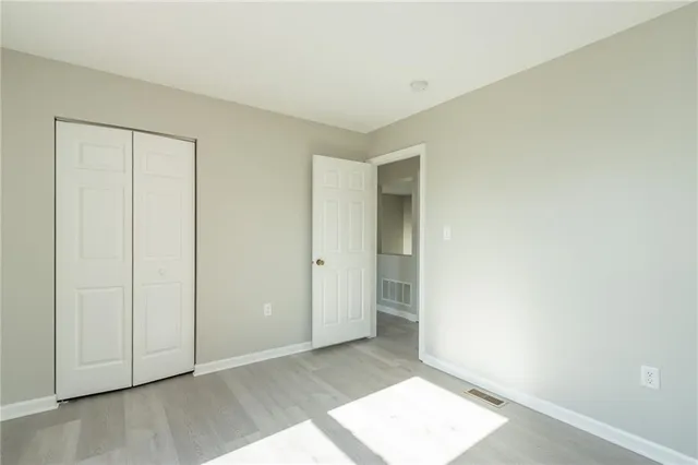 an empty room with wooden floor