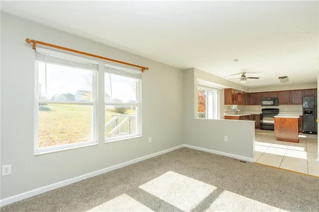 a view of a livingroom with furniture and a window