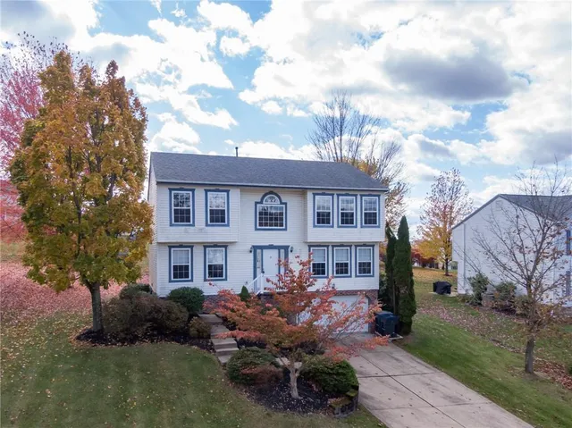 a front view of a residential apartment building with a yard