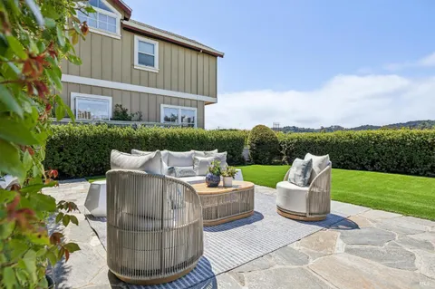 a view of a patio with couches chairs and a fire pit