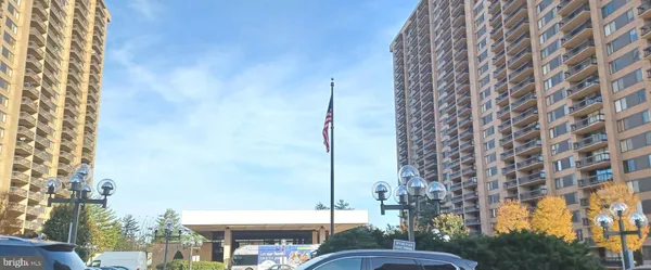 a palm tree sitting in front of a building