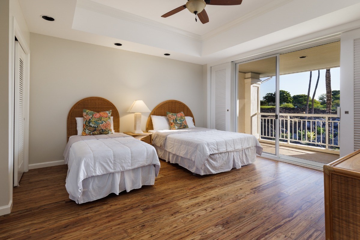 68-1375 Pauoa Road, Unit M2 Kamuela, HI 96743 - Photo 17 of 26 a bedroom with two beds and wooden floor