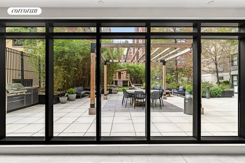 a view of a patio with dining table and chairs with wooden floor and fence