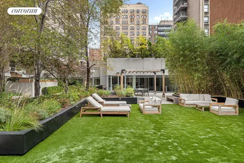 a view of a wooden deck and a yard in the back
