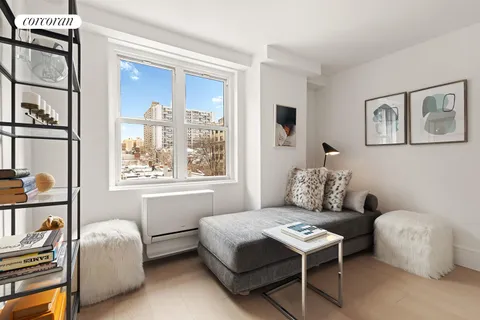 a bedroom with furniture and a window