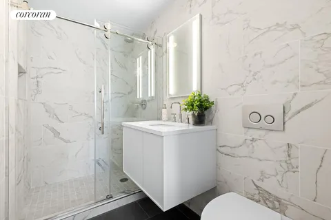 a bathroom with a sink toilet and shower