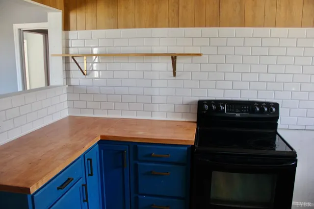 a kitchen with granite countertop cabinets and a stove top oven