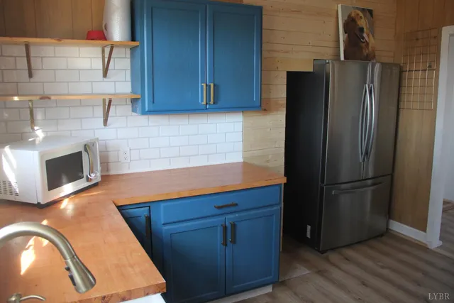 a kitchen with stainless steel appliances granite countertop a refrigerator and a stove