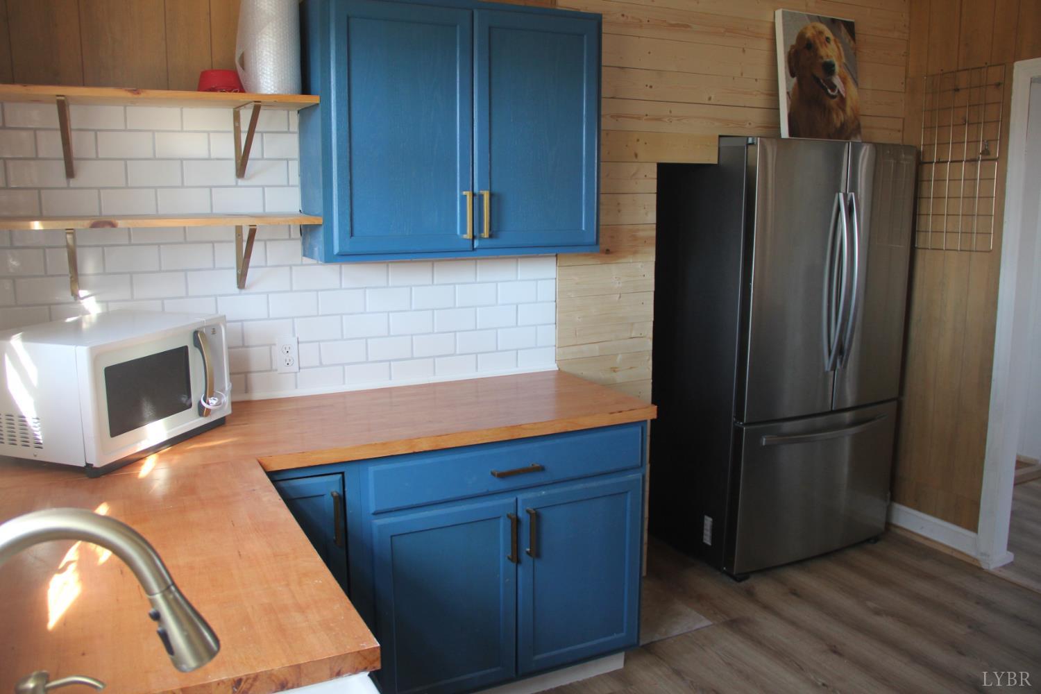 1140 Sunset Hill Road Big Island, VA 24526 - Photo 15 of 36 a kitchen with stainless steel appliances granite countertop a refrigerator and a stove