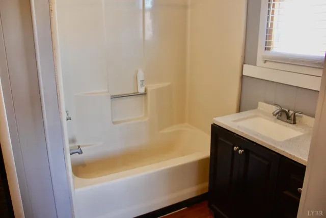 a white toilet sitting next to a small bathroom