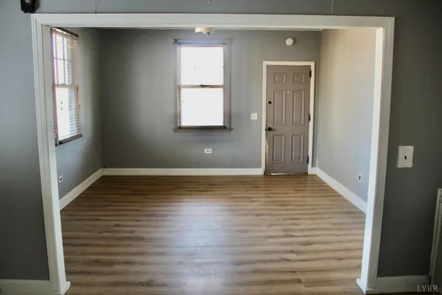 a view of a room with wooden floor and window